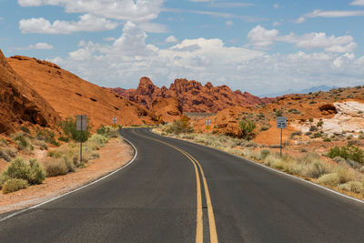 Road by mountain against sky