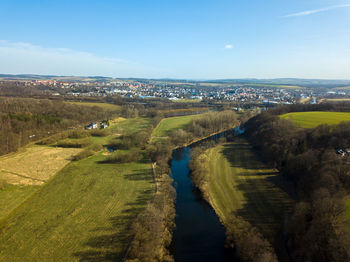 High angle view of cityscape and river against sky