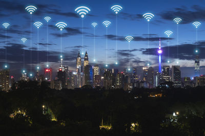 Illuminated modern buildings in city at night