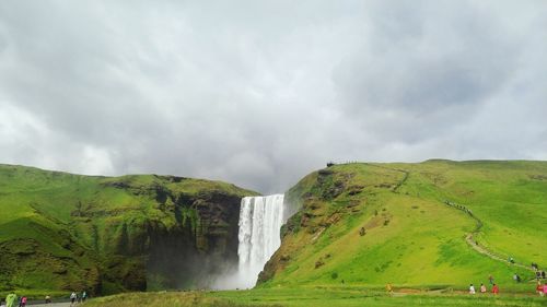 Scenic view of waterfall against sky