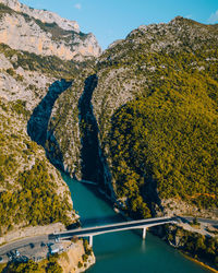 High angle view of footbridge over sea against mountains