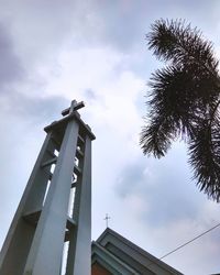 Low angle view of building against cloudy sky