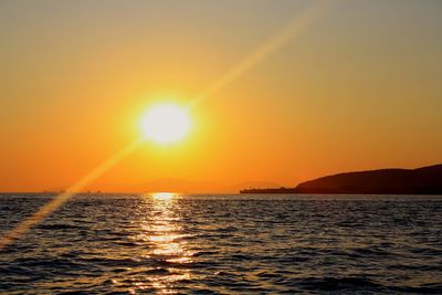 Scenic view of sea against orange sky