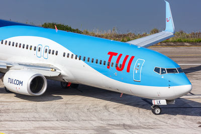 Airplane on runway against sky