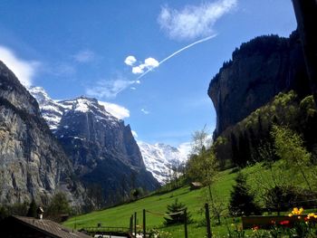 Scenic view of mountains against blue sky