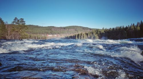 Scenic view of waterfall against clear sky