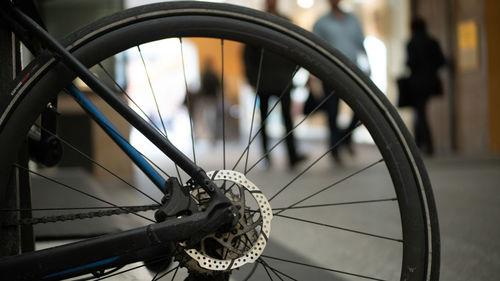 Close-up of bicycle wheel in city