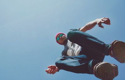 Directly below portrait of man against clear sky