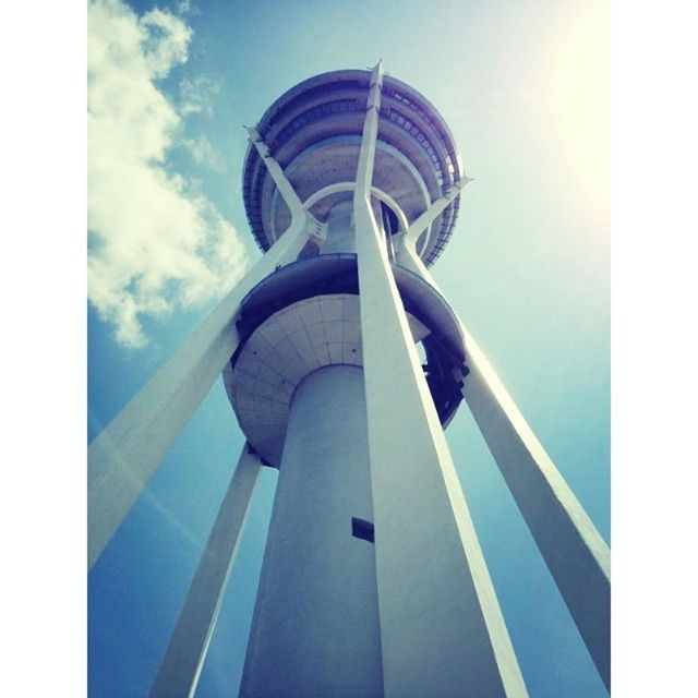 low angle view, architecture, built structure, tall - high, tower, modern, building exterior, sky, communications tower, transfer print, skyscraper, auto post production filter, travel destinations, famous place, office building, capital cities, city, international landmark, blue, tourism