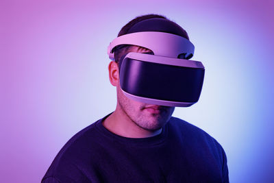 Portrait of young man against blue background