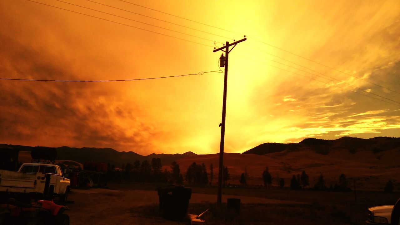 SCENIC VIEW OF SILHOUETTE MOUNTAIN AGAINST ORANGE SKY