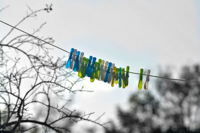 Low angle view of clothes hanging on clothesline against sky