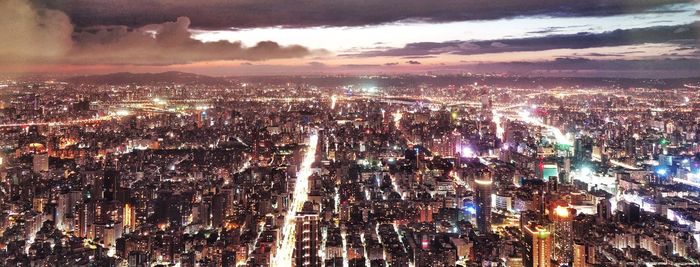 High angle view of illuminated city buildings at night