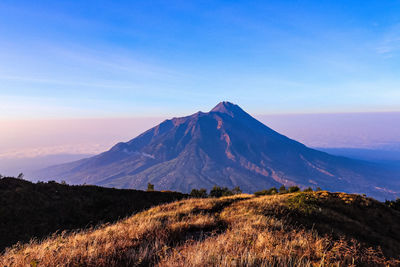 View of volcanic mountain against blue sky