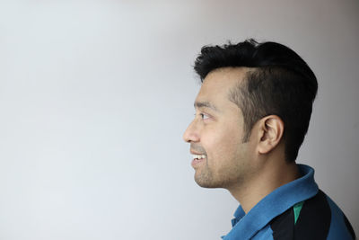 Portrait of young man against white background