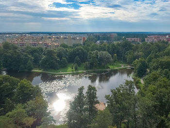 High angle view of trees and cityscape against sky