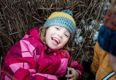 Portrait of young girl laying on the ground laughing looking