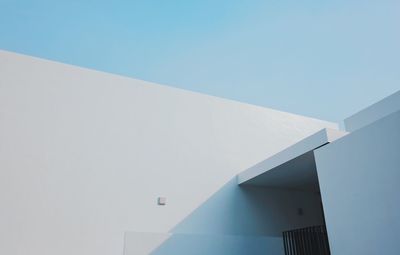 Low angle view of modern building against clear blue sky