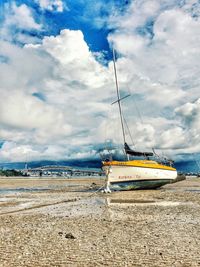 Boats in sea against cloudy sky