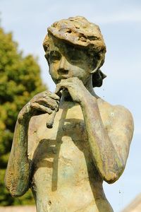 Close-up of hand statue against sky