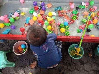 High angle view of boy playing with toys