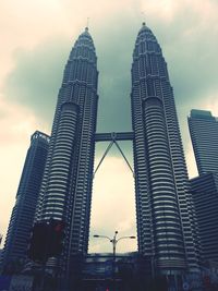 Low angle view of buildings against cloudy sky