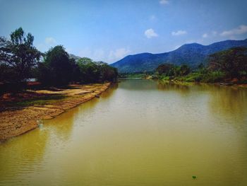 Scenic view of lake and mountains against sky