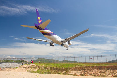 Low angle view of airplane flying in sky