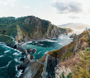 Panoramic view of sea and mountains against sky