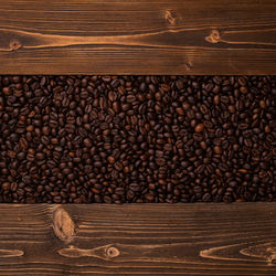 Close-up of roasted coffee beans on wooden table