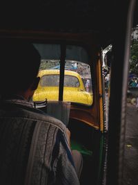 Rear view of man seen through car window