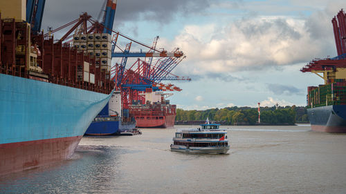 Commercial dock by sea against sky