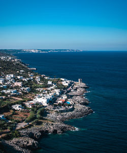 High angle view of sea and buildings against sky