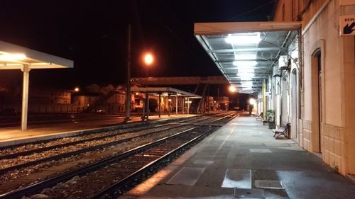 Empty railroad station platform at night