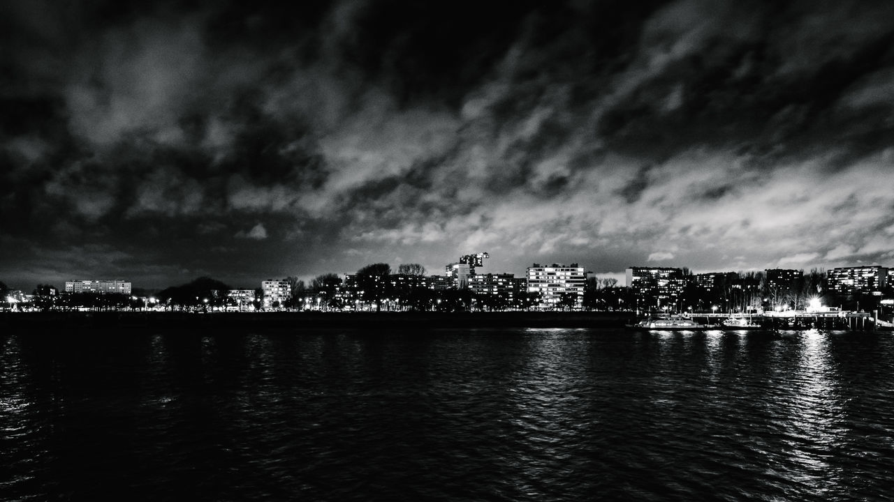 CITY AT NIGHT AGAINST SKY