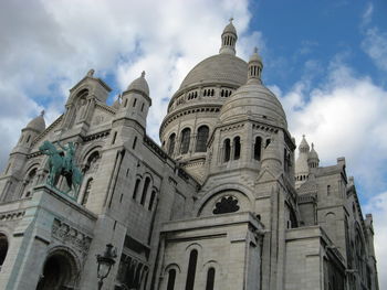 Low angle view of building against cloudy sky