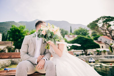 Woman sitting on top of potted plant