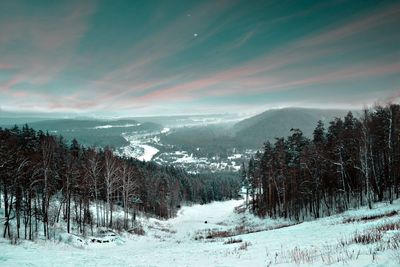 Scenic view of snow covered mountains against sky during winter