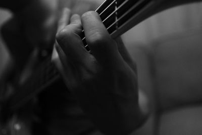 Cropped image of hand playing guitar