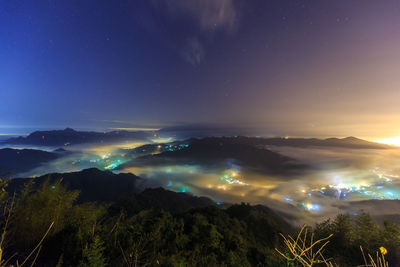 Scenic view of landscape against blue sky at night