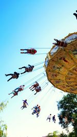 Low angle view of carousel against clear sky
