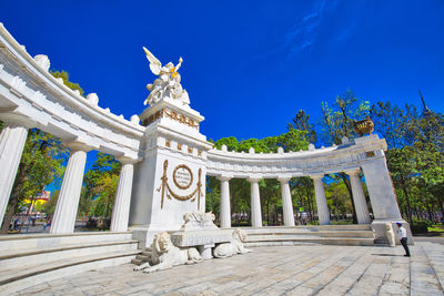 Statue of historic building against blue sky