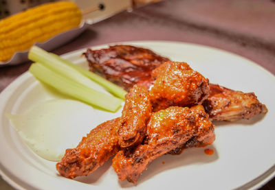 Close-up of chicken meat in plate on table