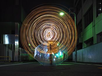 Illuminated ferris wheel in city at night