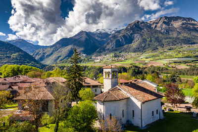 Houses by mountains against sky