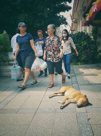 Full length of people with dog