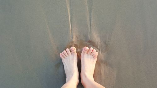 Low section of woman standing in water