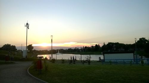 People on field against sky during sunset