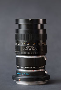 Close-up of camera on table against white background