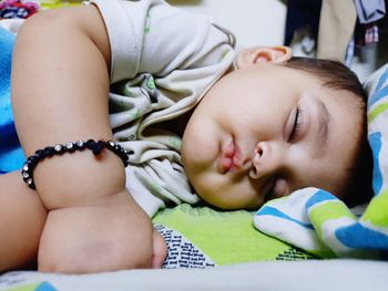 Baby girl lying on bed